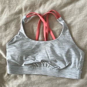 Gray/white striped lululemon sports bra with pink cross over straps